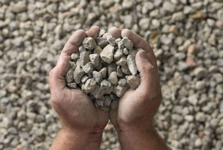 person holding 20mm aggregate